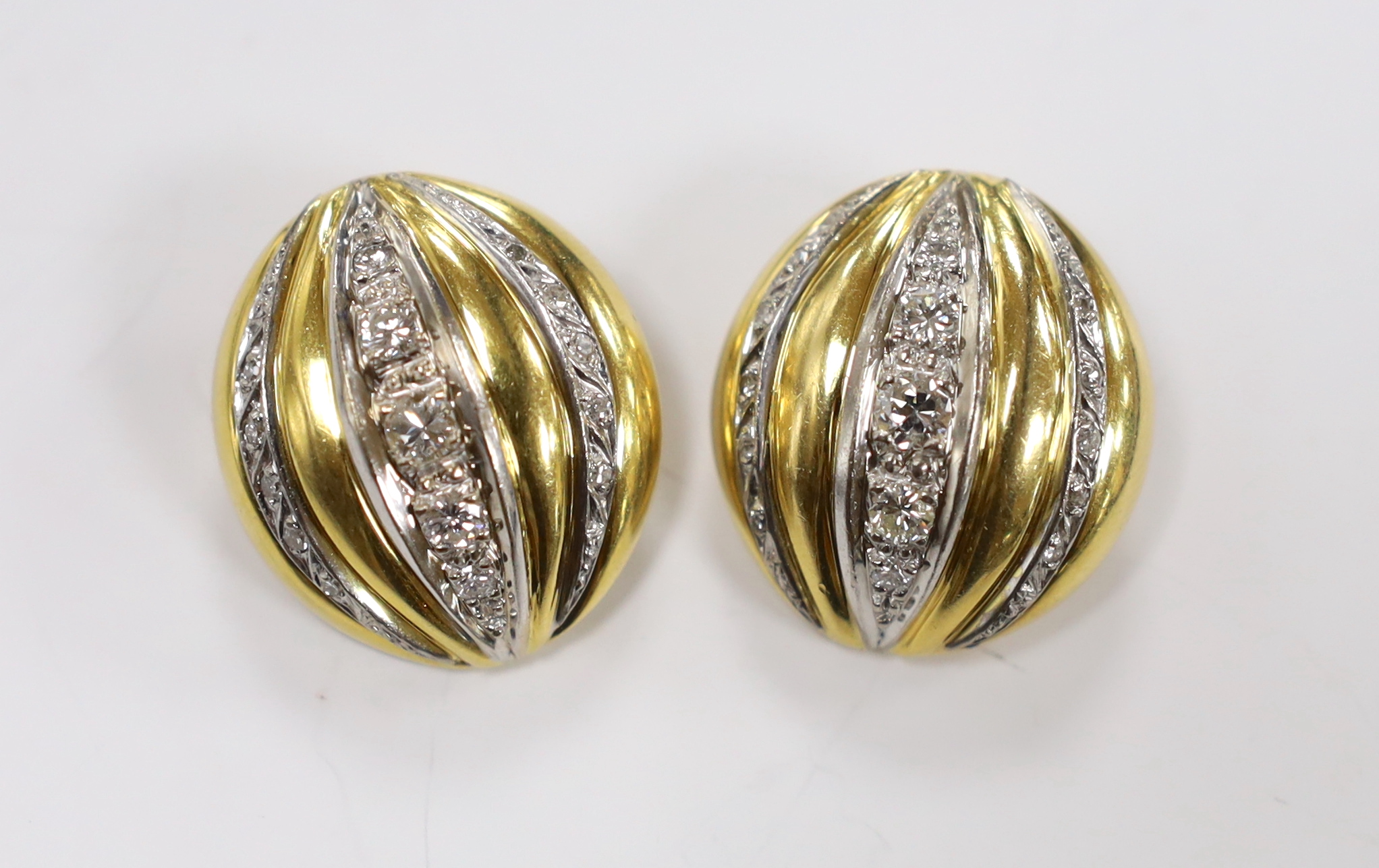 A pair of 18ct and diamond set three row line cluster fluted ear clips, 27mm, gross weight 26.7 grams.